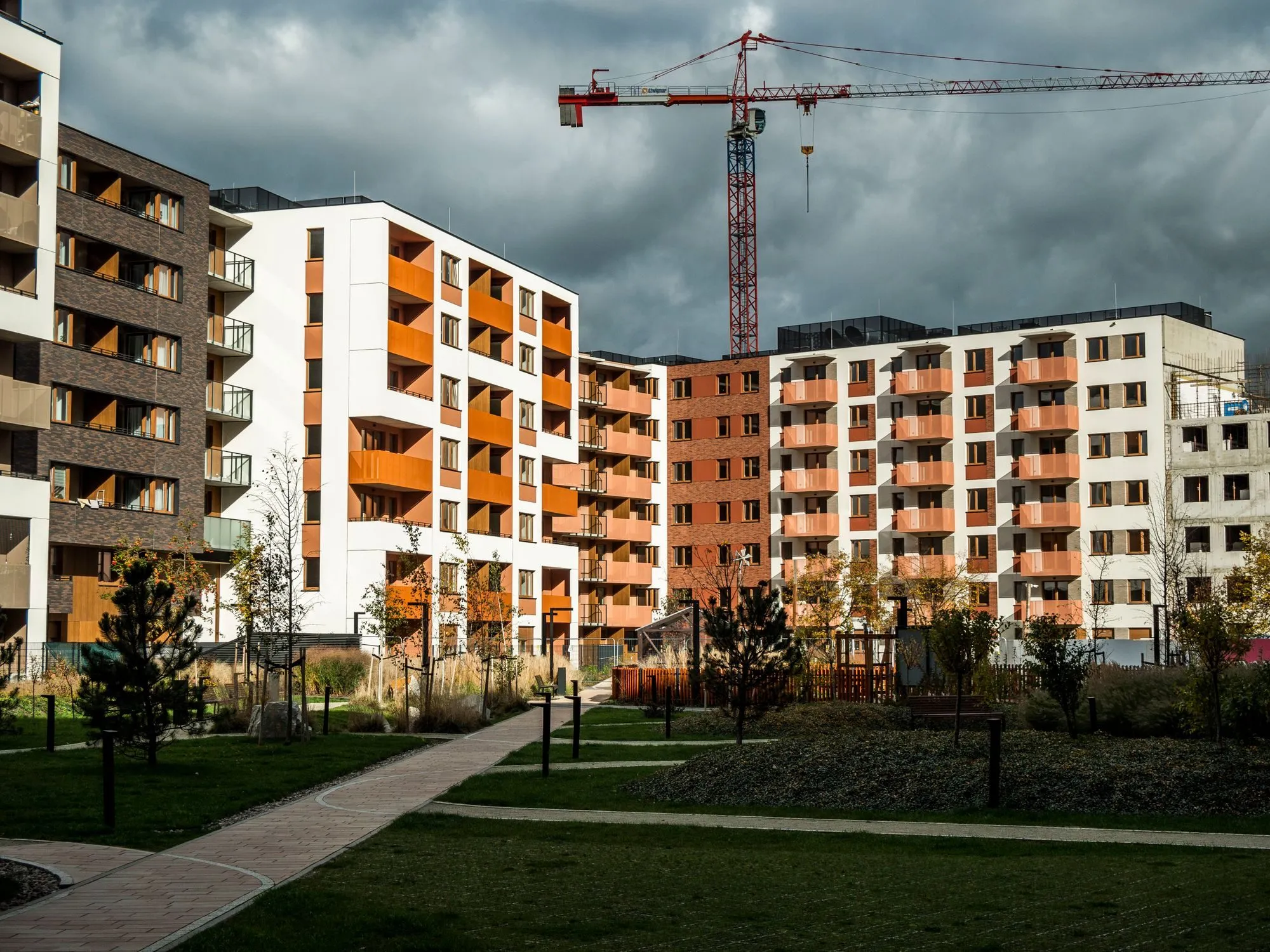 A tower crane beside a multi-storey building under construction