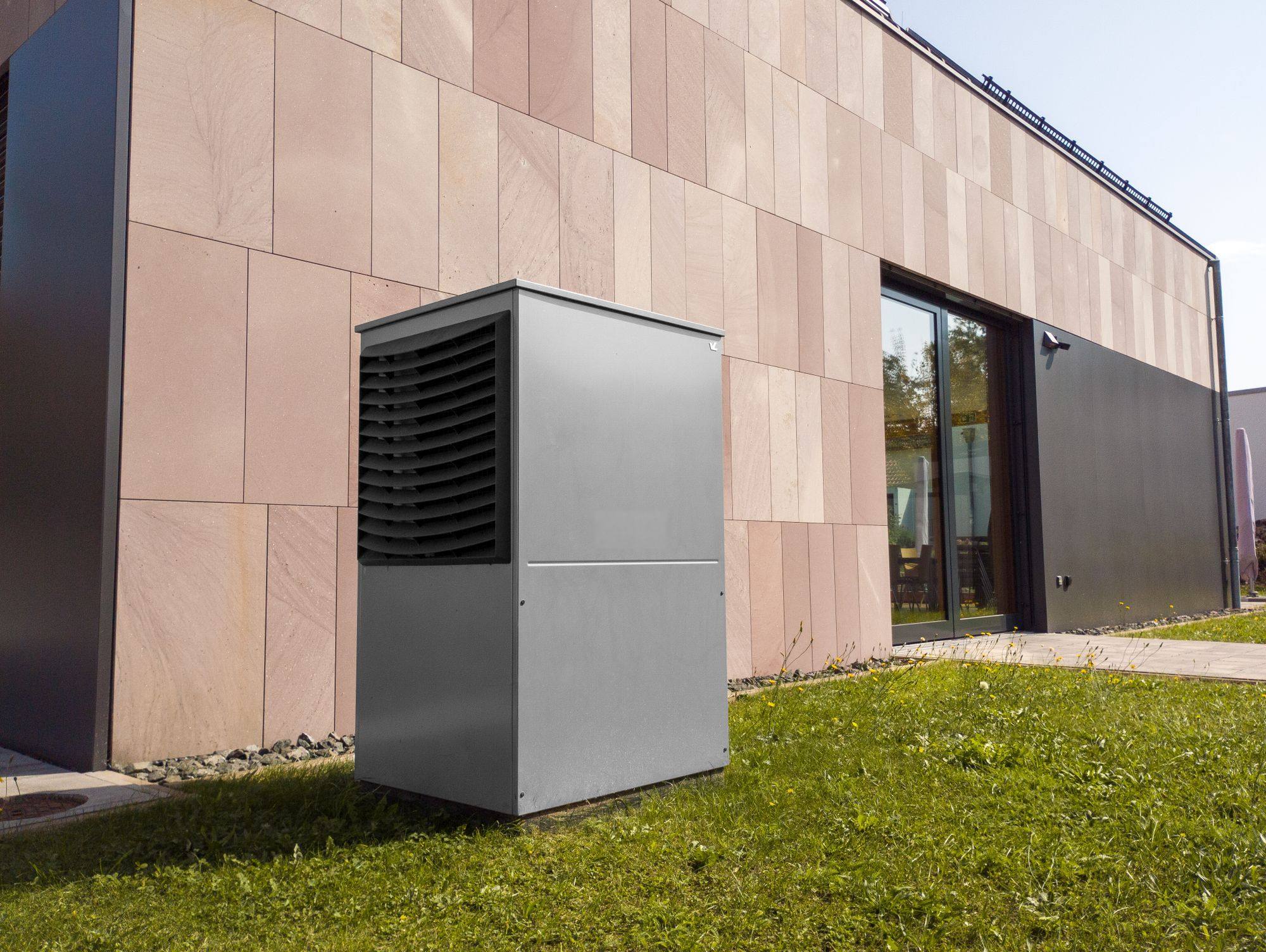 A heat pump unit outside a modern building