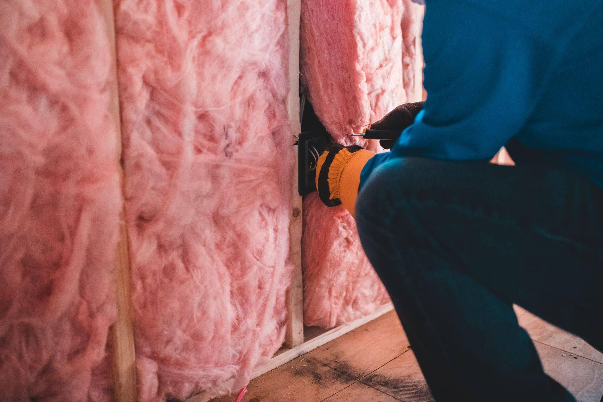 Insulation being fitted between timber studs