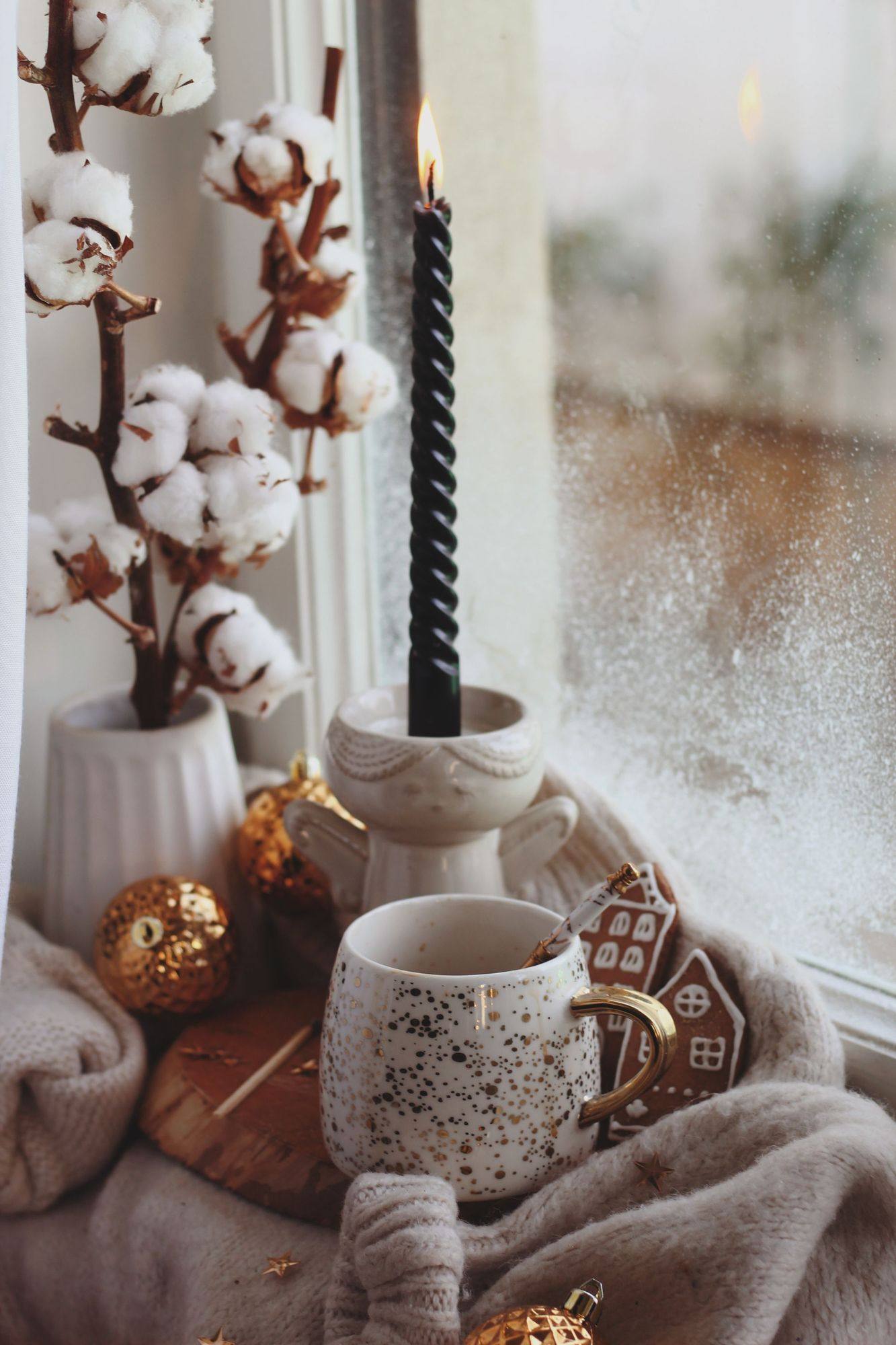 A warm drink beside a misted winter window