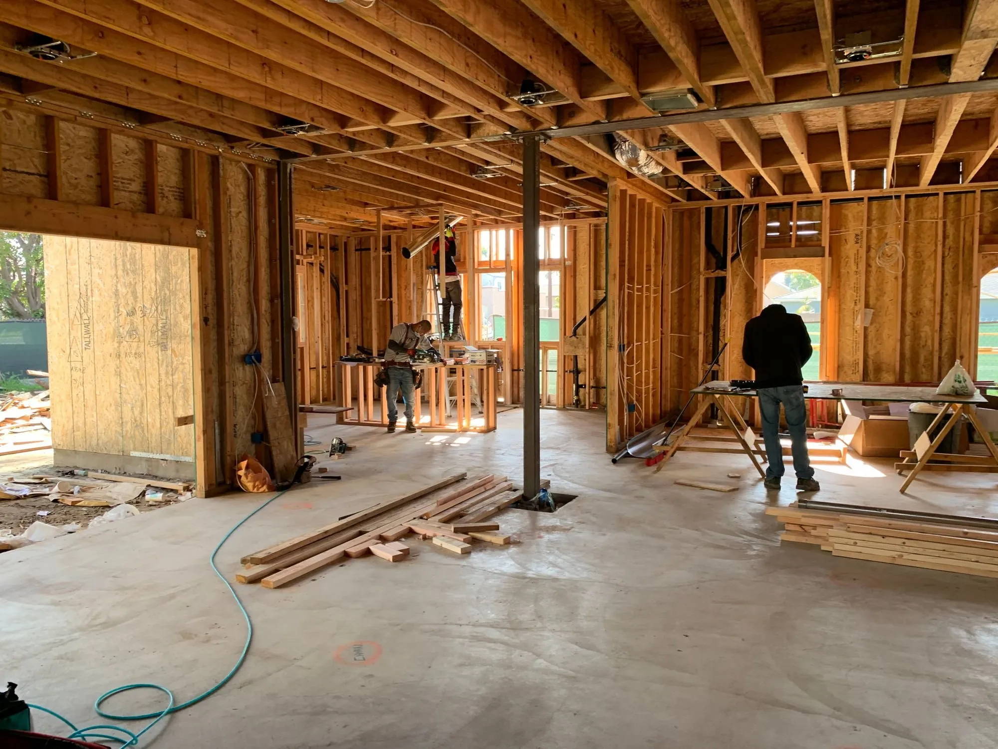 An unfinished timber-framed interior with exposed walls and floor